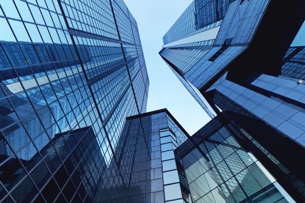 Looking up at mirrored glass office towers