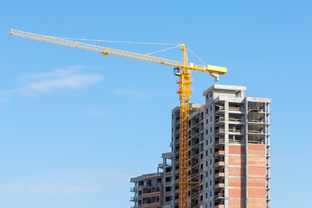 Tower crane beside a high-rise under construction