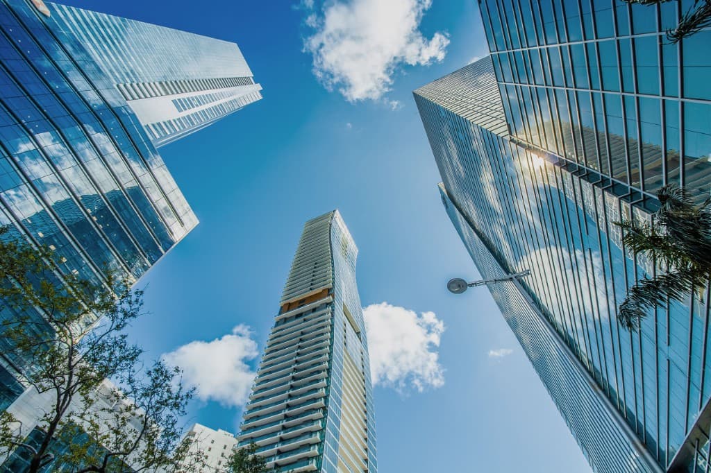 Modern glass skyscrapers against a blue sky