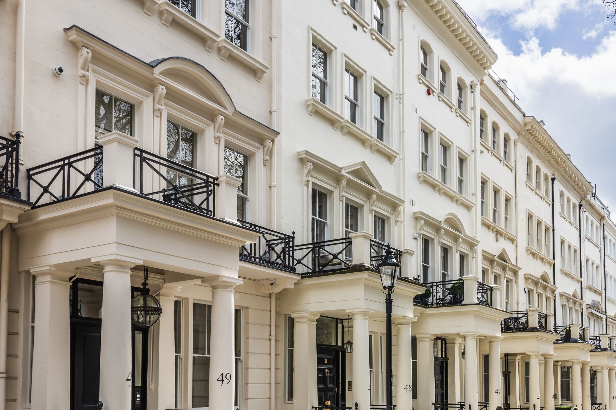 White stucco townhouses with black iron balconies